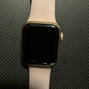 Rose gold Apple Watch SE with charger
